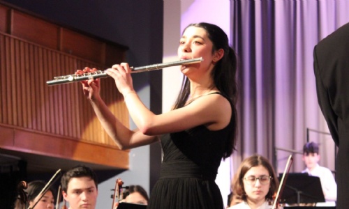 Student playing the flute during the concert
